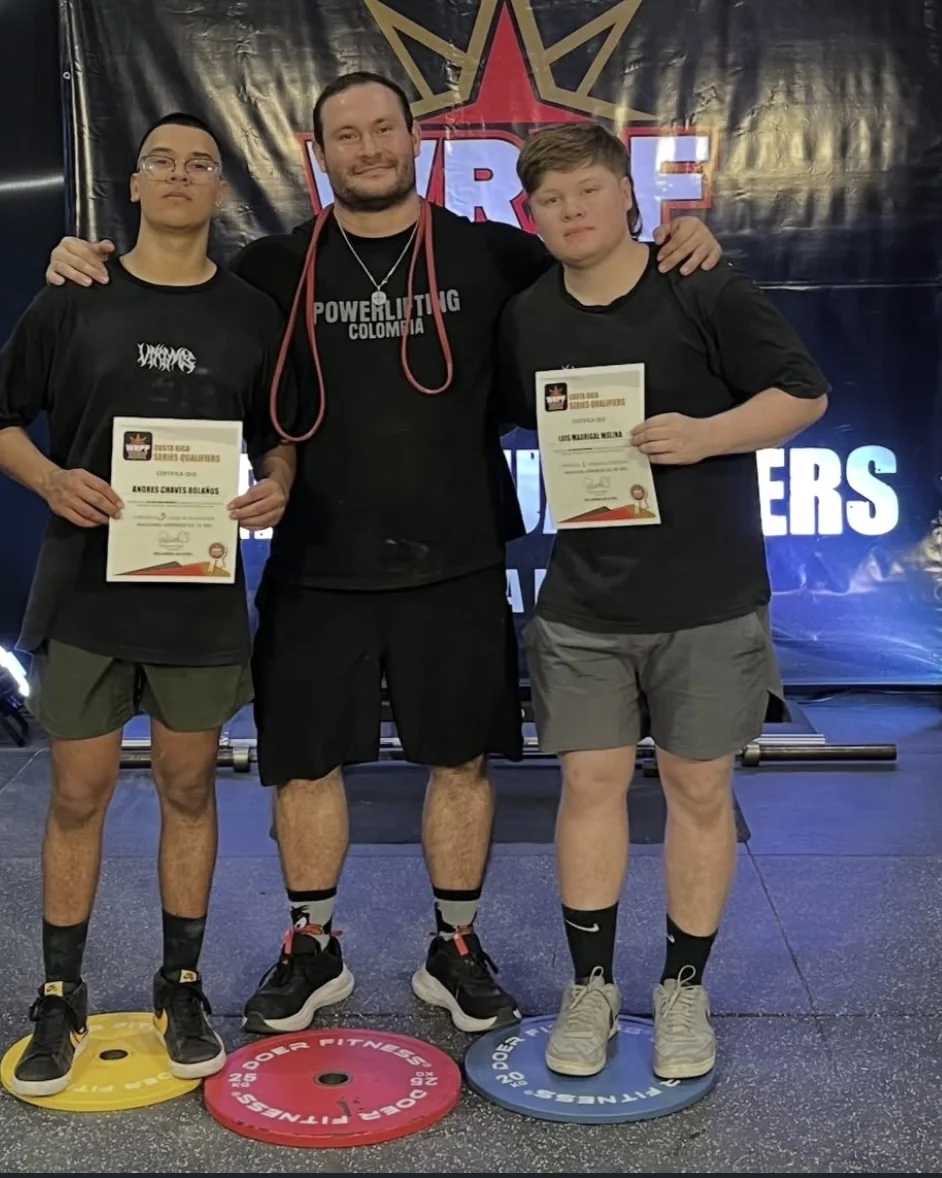 Two athletes coached by Douglas Lutz on the podium at the Costa Rica Series Qualifiers holding their certificates