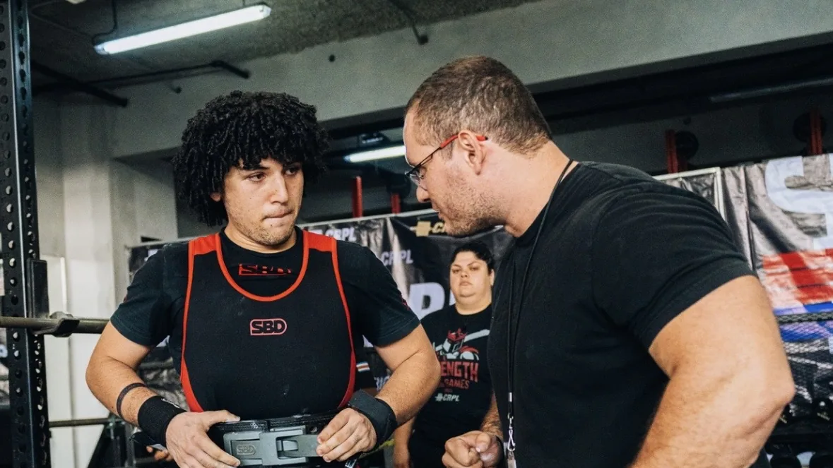 Douglas Lutz giving an athlete a cue before an attempt at a CRPL competition