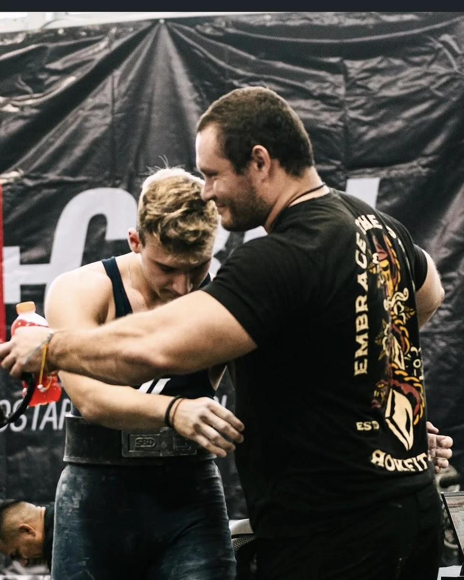 Douglas Lutz with an athlete immediately after a lift at a competition