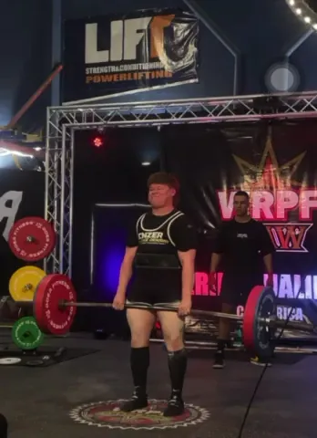 Athlete locking out a deadlift at a competition